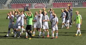 The Boy's Varsity Soccer Team proudly presents the second place State trophy to the crowd. 