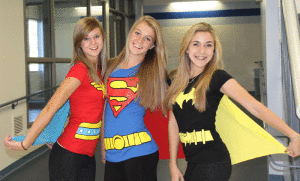 From left to right: Kayla Wiitala, Katie Rainsberger, and Mckenna Merrill uncover their super identities for Halloween.