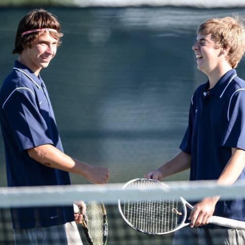 Jake Thornally and Blaine Wuertz congratulate eachother after a win in a tennis match.