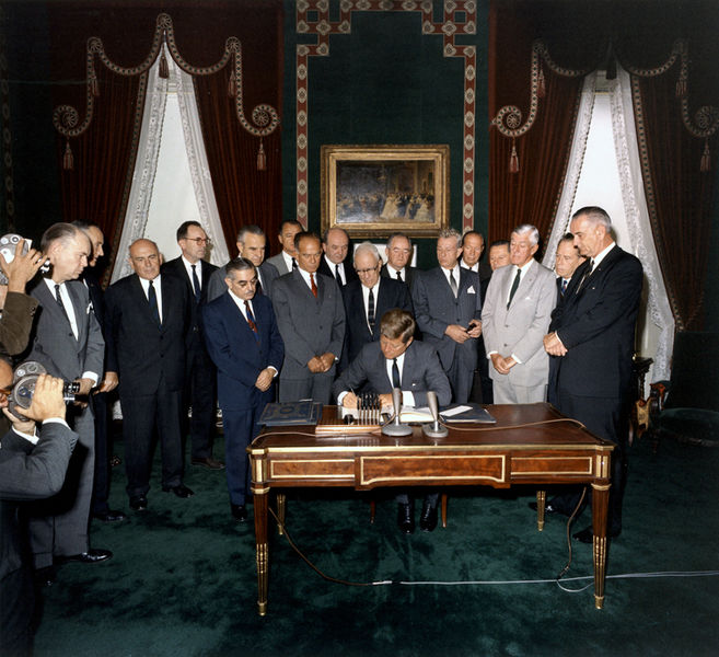 [Arms Treaty signing with President Kennedy] Photo Via Wikimedia Commons under the Creative Commons license. [http://commons.wikimedia.org/wiki/File:President_Kennedy_
signs_Nuclear_Test_Ban_Treaty,_07_October_1963.jpg]