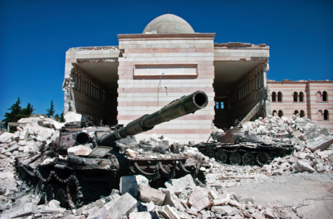 A photo shot in the ruble of a building damaged from Syrian Civil War. Photo via Wikipedia under the Creative Commons License. https://en.wikipedia.org/wiki/Syrian_civil_war 