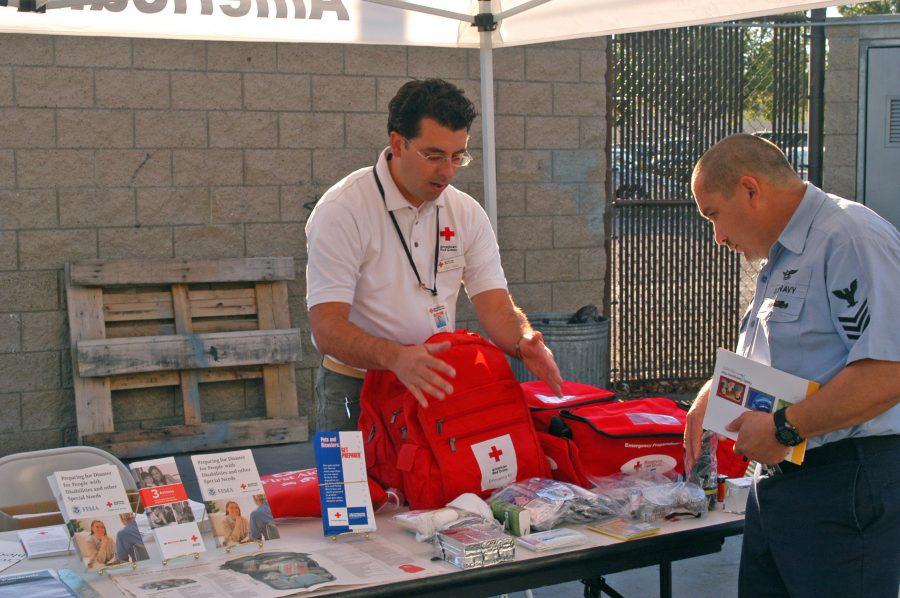 061027-N-8909B-019
San Diego (Oct. 27, 2006) - Cruz Ponce, the development and communications coordinator for American Red Cross, shows Aviation Structural Mechanic 1st Class Jose Campa some first aid equipment used for disaster relief at the Helicopter Sea Combat Wings Emergency Preparedness Fair, at Naval Base Coronado. The fair included training seminars that provided emergency survival information to Sailors and their families. U.S. Navy photo by Mass Communication Specialist Seaman Cale Bentley (RELEASED)