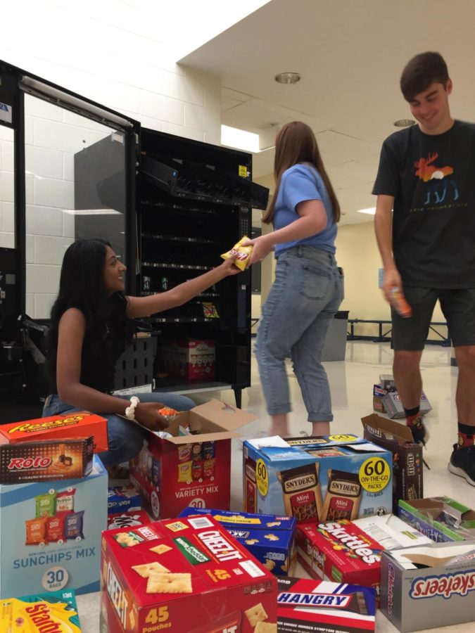 Air Academys forensics speech and debate captains restock Lola during first period. Pictured left to right: Nidhi Unnikrishnan, Mackenzie Hardage, Sam Brooks. 