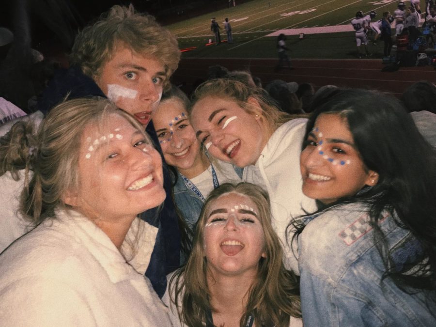 A group of AAHS juniors smiling at the white out football game at Cheyenne Mountain, captured moments after cups full of flour were thrown in the cold air. (Top row left to right: Carter Wood, Megan Pharris, Casey Hogan. Bottom row left to right: Acacia Ryska, Callissa Steel, Parmida Mahdavi.)