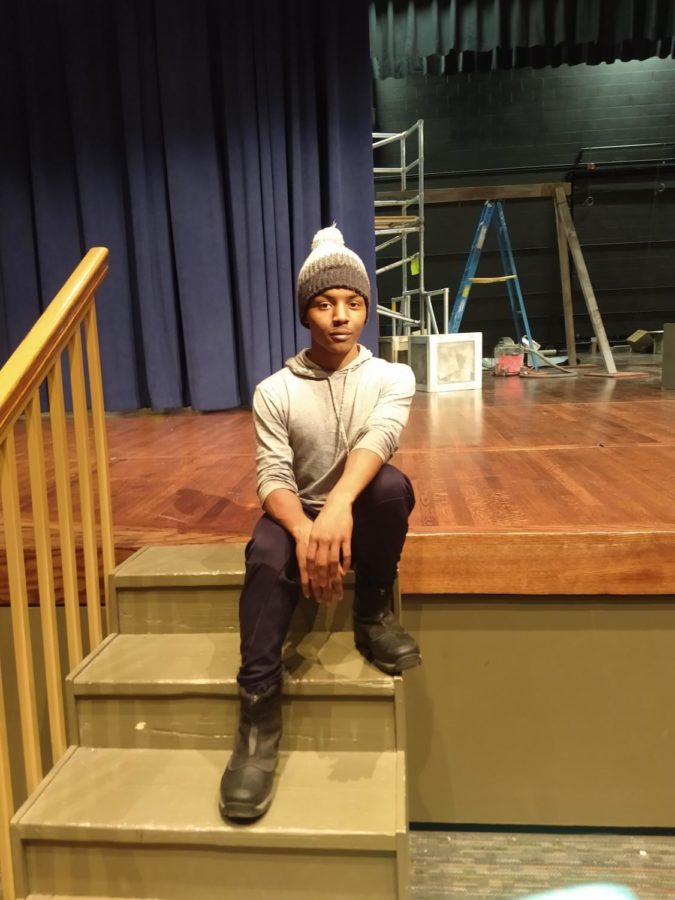 Naheim Colon-Sanders sits onstage where many performances have been and where he hopes more will take place.