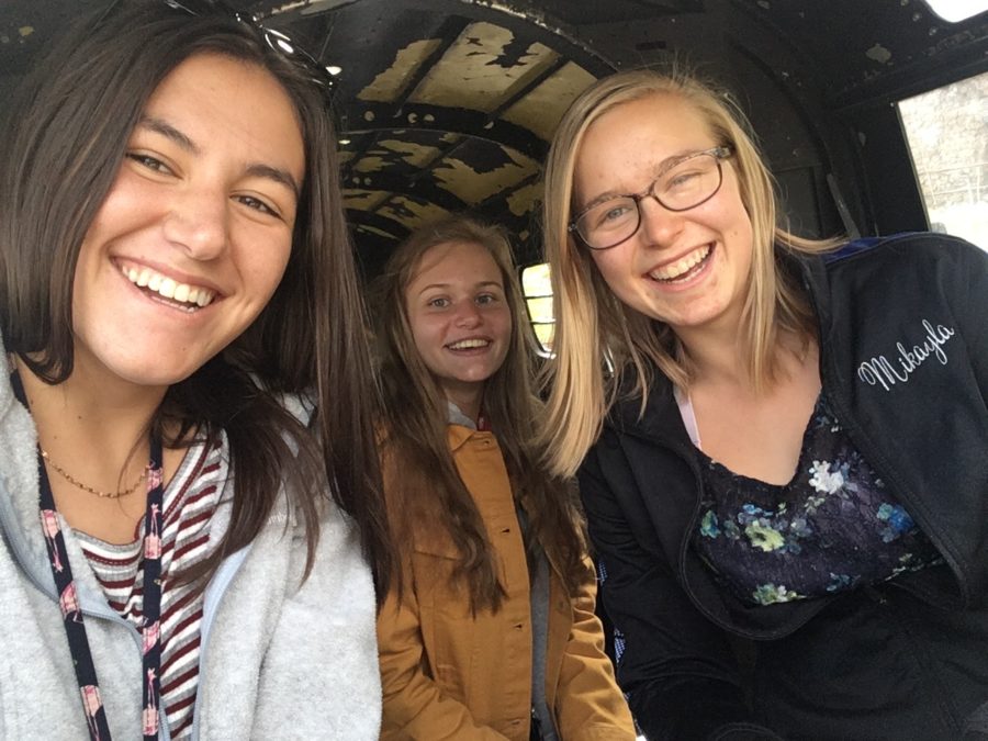 Junior Amaya Walker, Senior Ashley Holsinger and Senior Mikayla Britsch sit in a airplane at the Cheyenne mountain zoo, where the scavenger hunt for Spanish Honor Society took place.