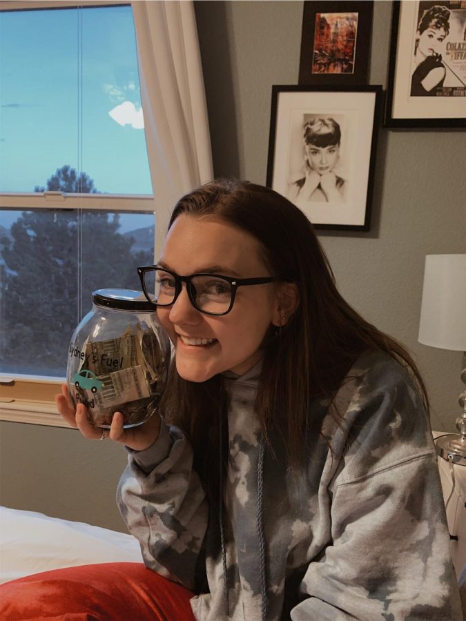 Senior Sydney Pruitt shows off her fuel fund, a jar she started collecting money in after she bought a car.