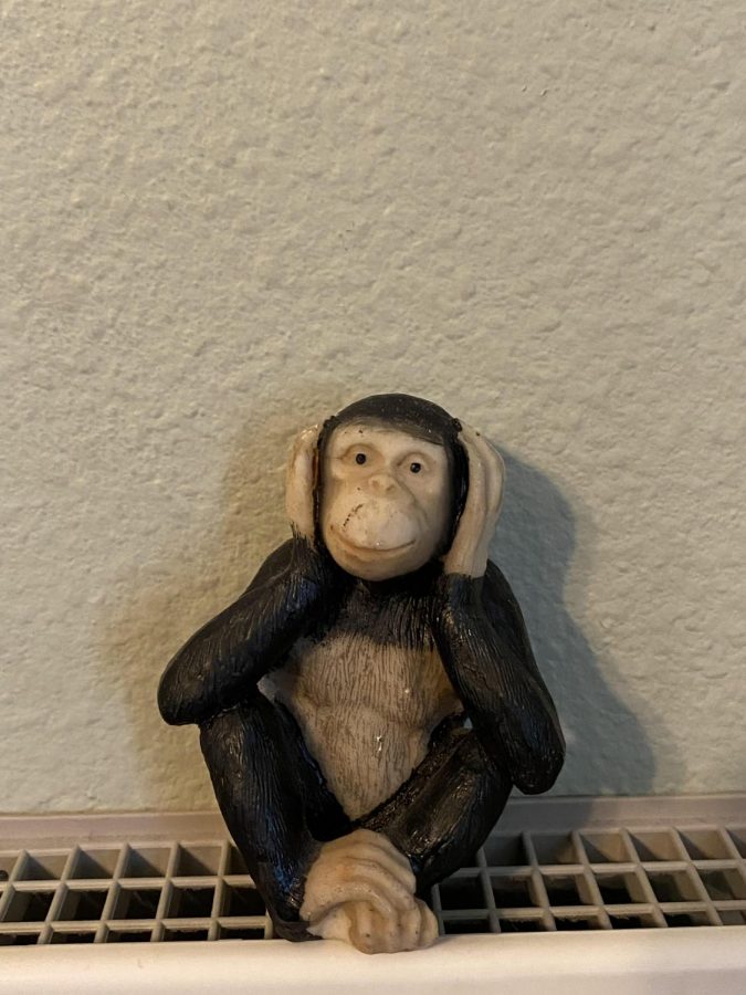 A wood carving of one of the Three Wise Monkeys portrays the phrase hear no evil, which originated from Japanese folk lore.