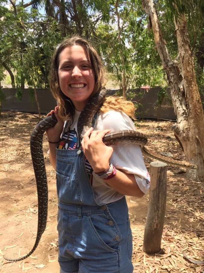 Air Academy graduate Julia Helle poses with a snake during her gap year in Australia.