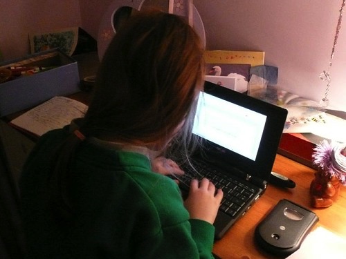 Labeled for Reuse from Creative Commons. A student concentrates and remains engaged while completing an online assignment. 