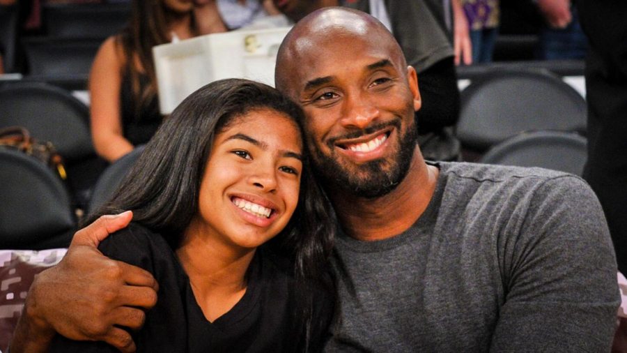 Image labeled for reuse by Insider.com.
Kobe Bryant and Gigi Bryant watch a Lakers game together. 
