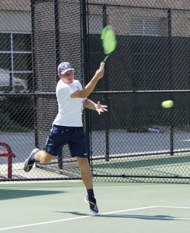 Noah Hellem returns the tennis ball in a hard fought battle during the Colorado State Championships.