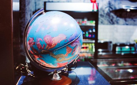 A majestic globe containing constellations sits on a table. Labeled free for reuse by Unsplash. 