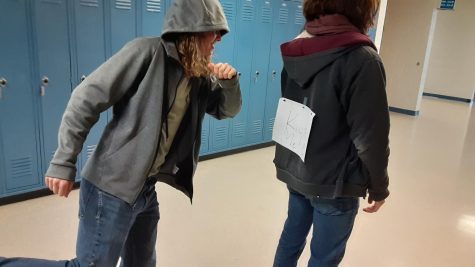 Senior Nathan unsuspectingly walks down the halls as a student prepares to prank him.