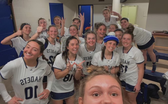 The Air Academys Girls lacrosse team joining together after winning a game. 