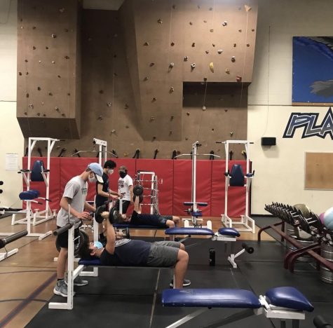 The Air Academy wrestling team lifts in the  weight room during practice.