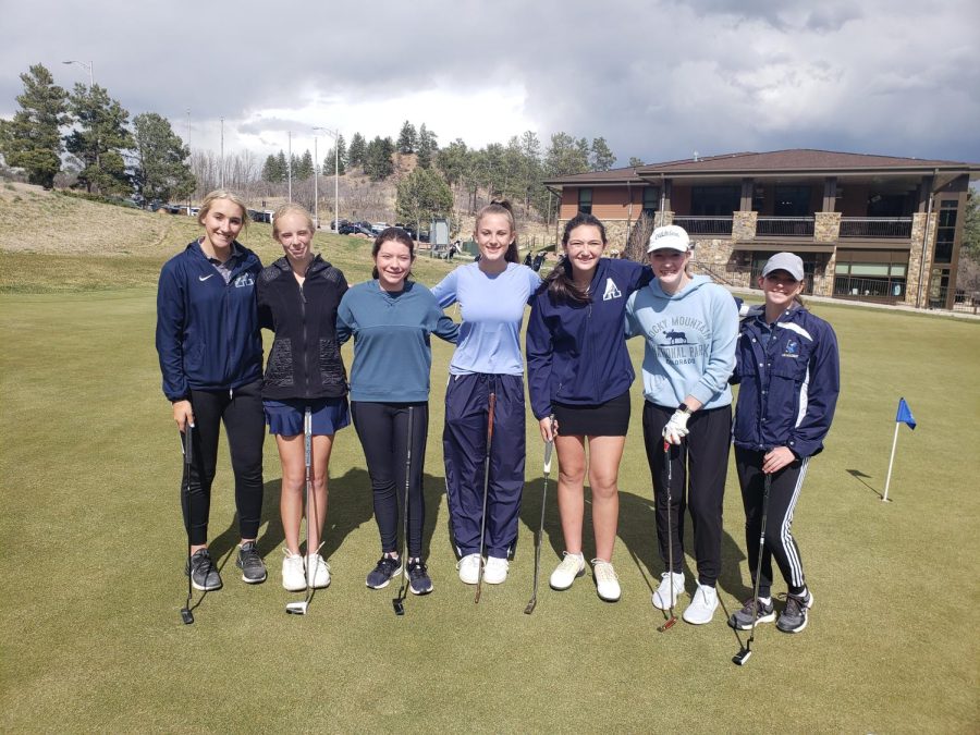 The+girls+golf+team+smile+proudly+as+their+coach%2C+Jason+Catron%2C+takes+a+picture.+