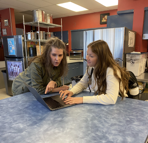 Family and Consumer Sciences teacher, Laura Armstrong, helping senior Ashlynn Olson fill out her common application!