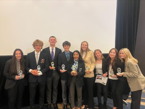 A group of Air Academy High School DECA students looking absolutely elated after receiving an event award! Students mentioned from left to right: Lauren Behar (12), Nate Lumaye (11), Finn Horsfall (12), Kian Jiang (12), Ratna Unnikrishnan (12), Paige Uebelhoer (12), Alex Gales (12), Abigail Weaver (11), and Erin Bailey (11).