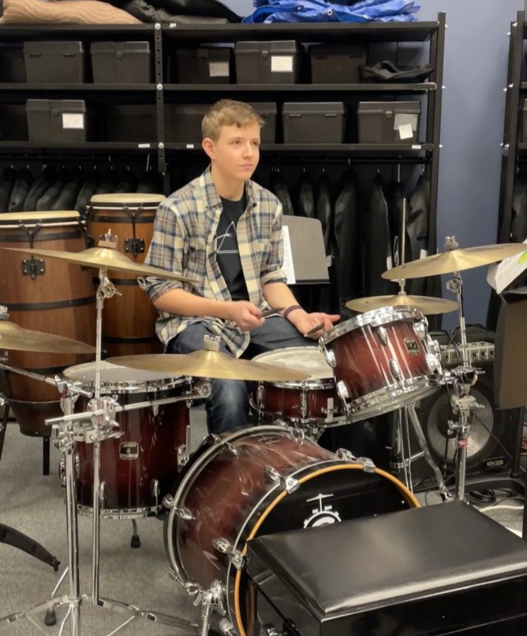 A student practicing during lunch in the band room for Battle of the Bands.