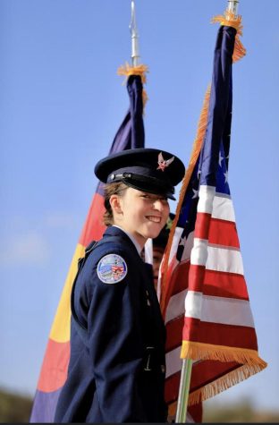 Senior Vice Wing Commander, Natalie Inazu, in her service dress uniform posing in front of both the Colorado state flag and the American flag. Taken by her father, Mike Inazu. 
