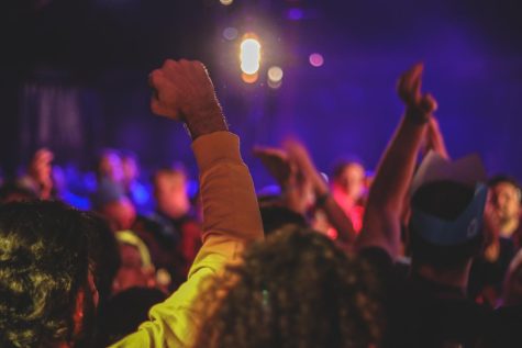 Many people partying and dancing happily. Free image from Unsplash.