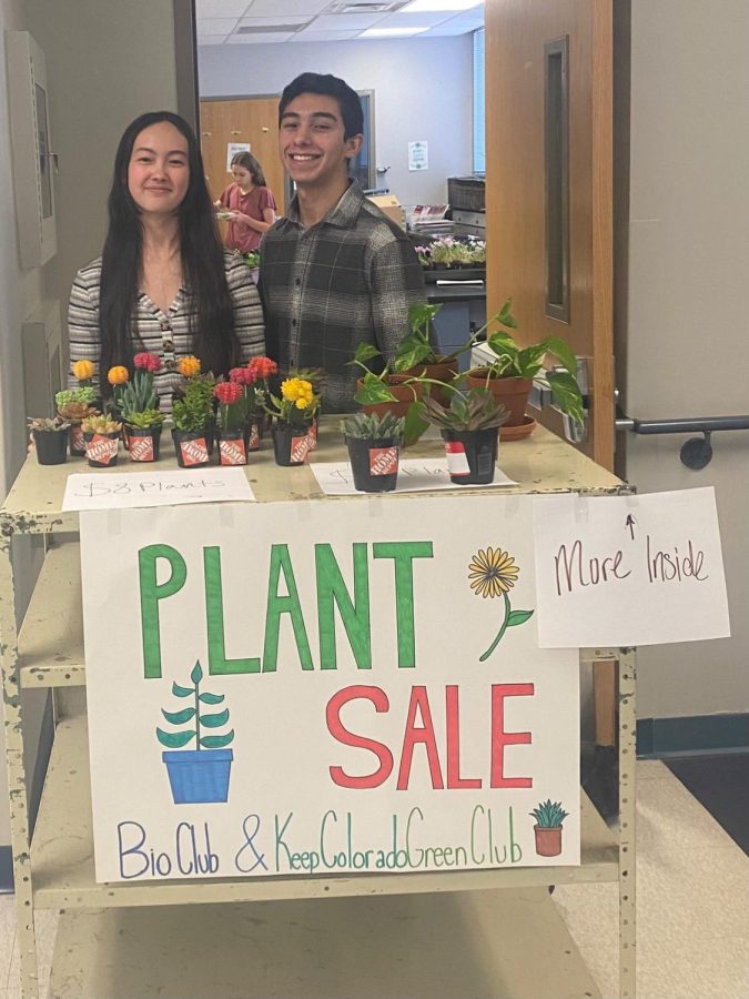 Junior Meena Lee and sophomore Jacob Mortensen posing behind the plant sale sign with various, cacti, succulents, and more! Taken outside of Ms. Hatchers classroom on April 17th.  