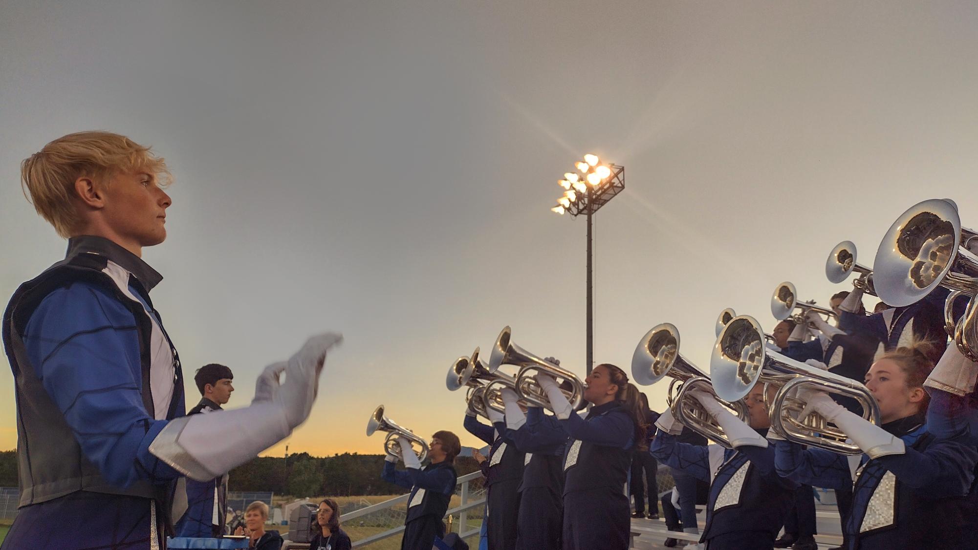 Junior, drum major, William Schuh directs the band at an Air Academy High School football game.