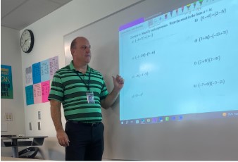 Mr. Jones explaining a new math lesson in Algebra 2.