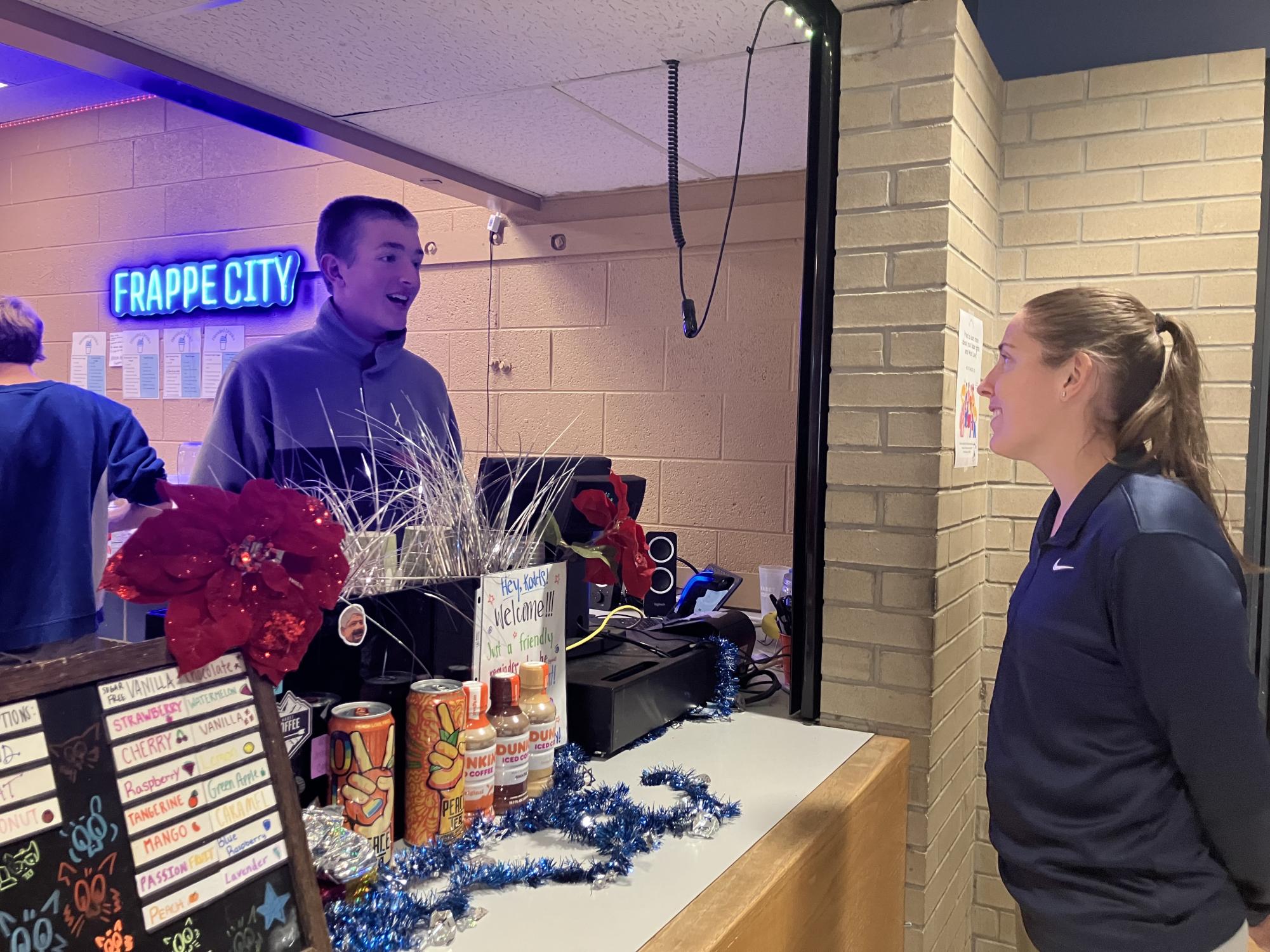 Assistant Principal, Kali Maxwell ordering a drink from a Kadet Coffee employee, Blaise Horsfall. 