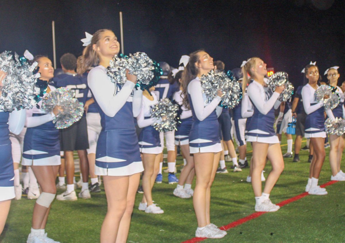 AAHS+Cheerleading+spiriting+to+the+crowd+during+a+home+football+game.
